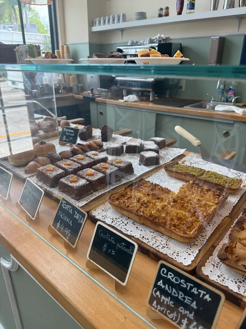 bakery display case with chocolate cakes, pastries, and italian desserts., mamma leone, miami