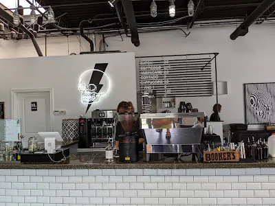 modern café counter with baristas, espresso machine, menu board, and neon signage., manchester coffee co., lexington