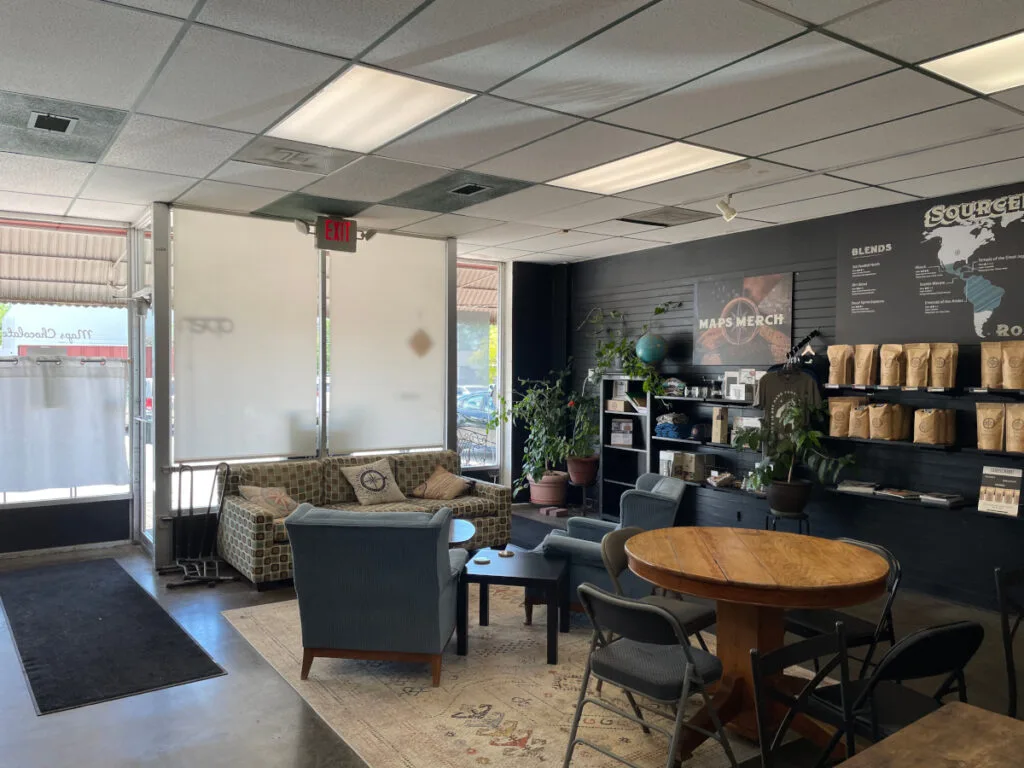 coffee shop interior with seating area, retail shelves, and merchandise displays., maps coffee & chocolate, lenexa