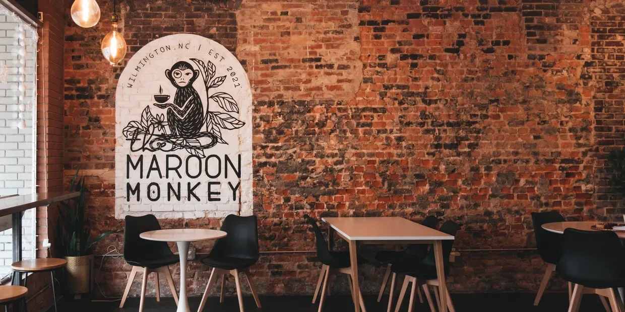 maroon monkey café interior with brick walls and modern seating furniture., maroon monkey coffee, wilmington