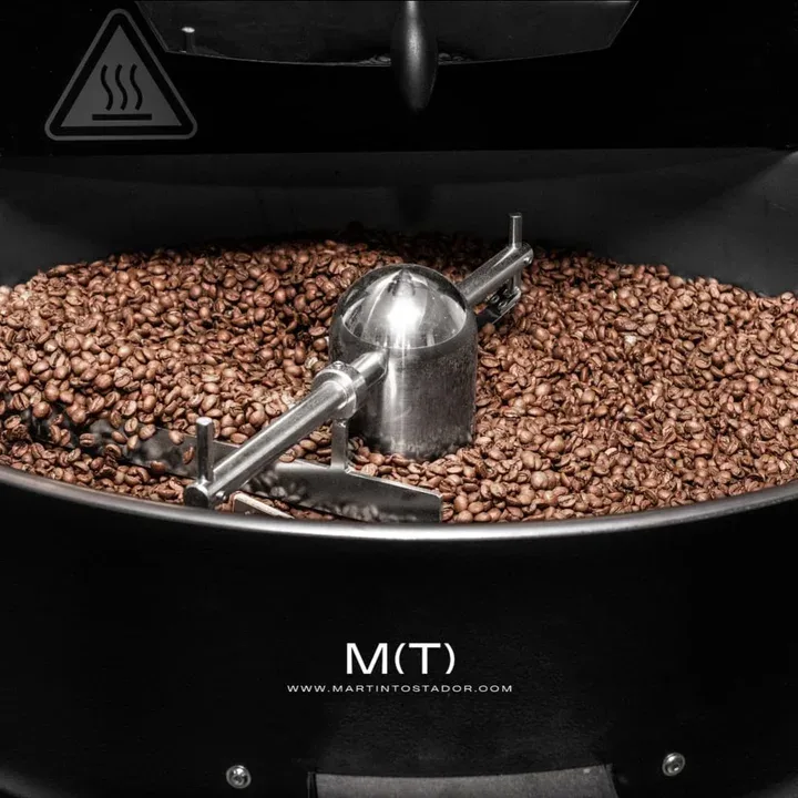 coffee roaster drum filled with roasted beans and metal stirring mechanism., martín tostador (café de especialidad), madrid