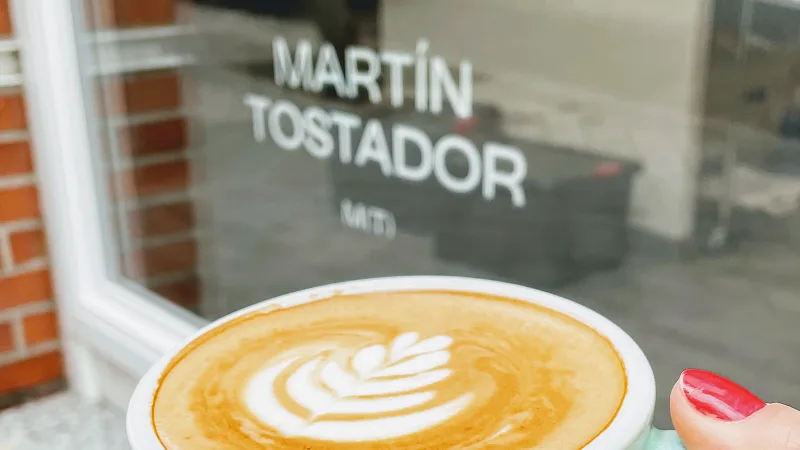 latte with latte art in front of martín tostador café storefront window., martín tostador (café de especialidad), madrid