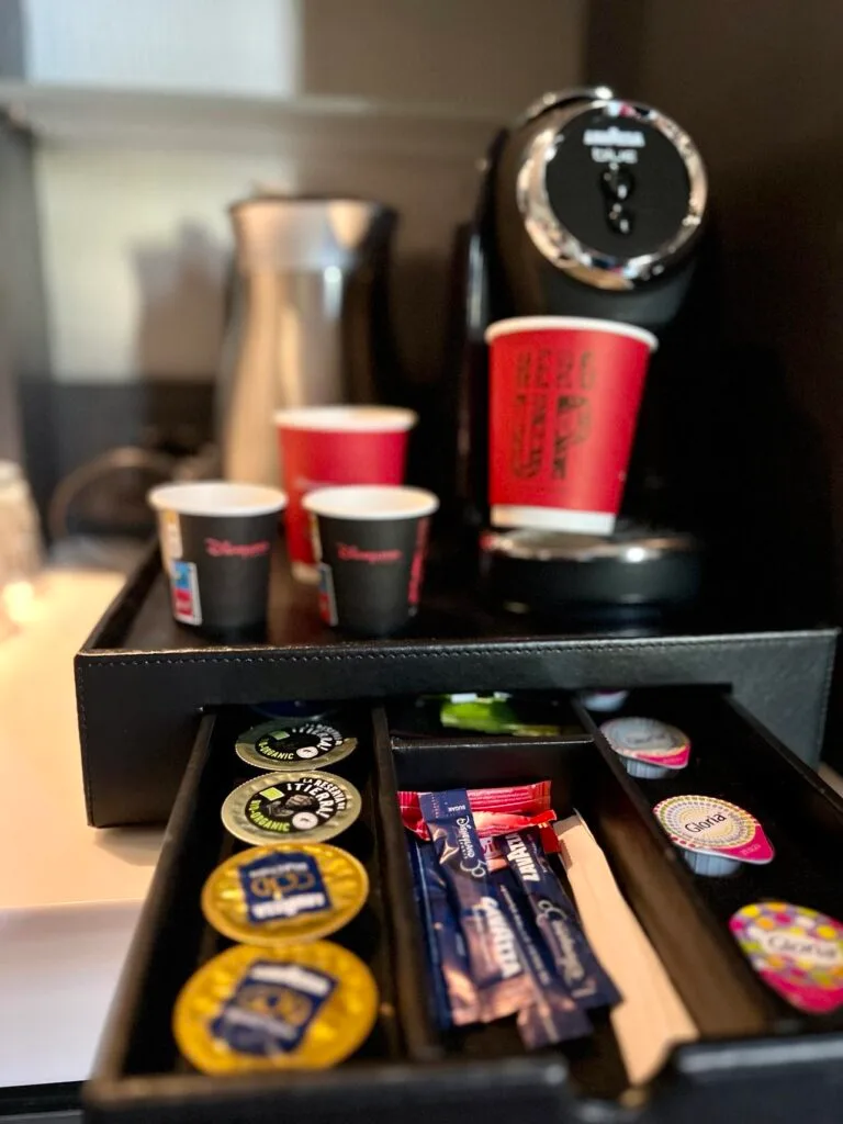 single-serve coffee maker with cups, capsules, and accessories organized in drawer storage., marvely, paris