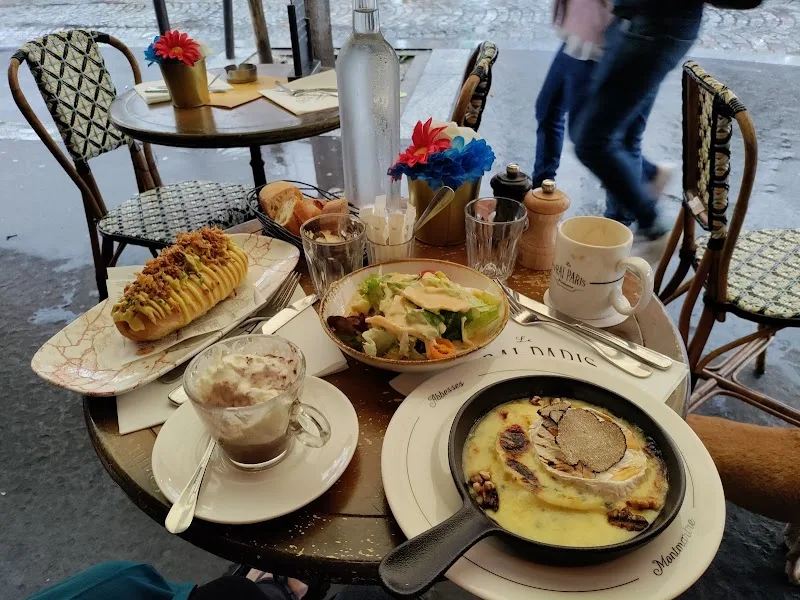 outdoor café table with pastries, omelette, coffee, and fresh flowers in paris., marvely, paris