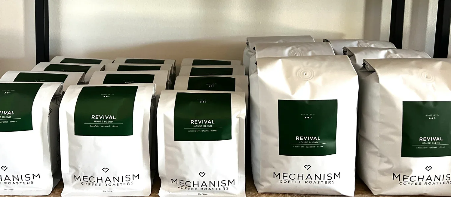 multiple bags of revival house blend coffee from mechanism coffee roasters displayed on shelf., mechanism coffee roasters, ja