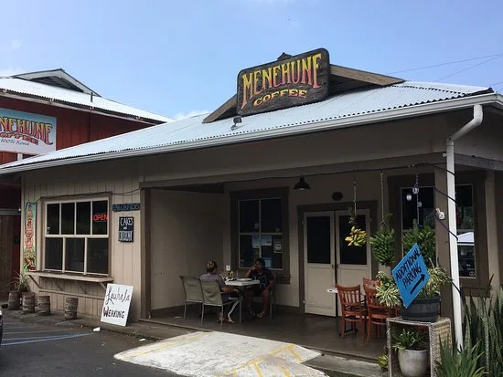vintage storefront with "henchcune" sign, covered porch, seating area, and plants., menehune coffee company, honaunau-napoopo