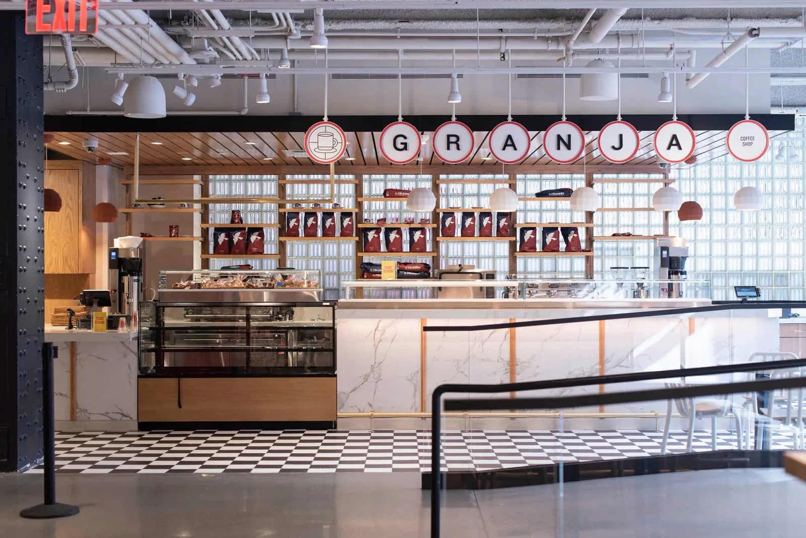 modern coffee shop interior with "granja" signage and marble countertop design., mercado little spain, new york city