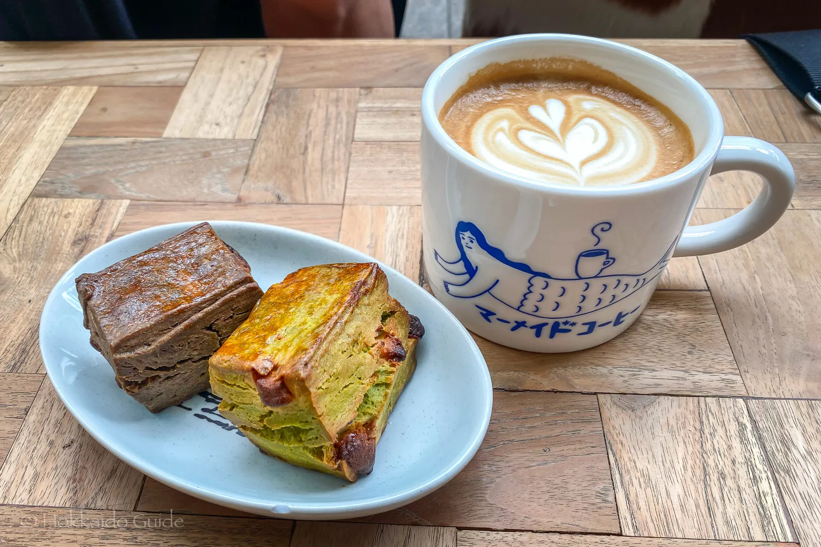 latte with latte art and two slices of cake on wooden table., mermaid coffee roasters, sapporo