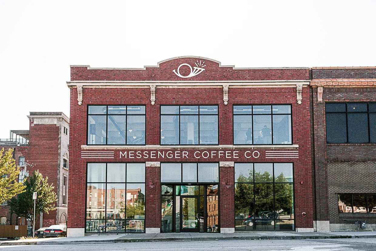 red brick building with "messenger coffee co" storefront and large windows., messenger coffee co. + ibis bakery, kansas city