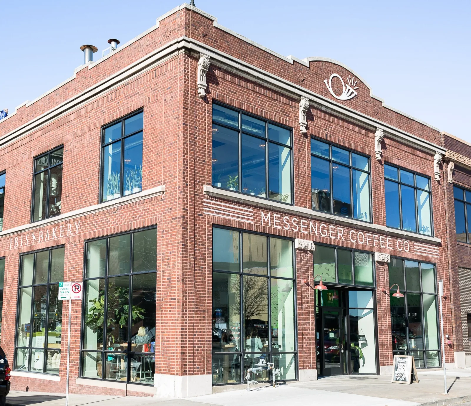 brick building with "messenger coffee co" storefront and large windows., messenger coffee co. + ibis bakery, kansas city