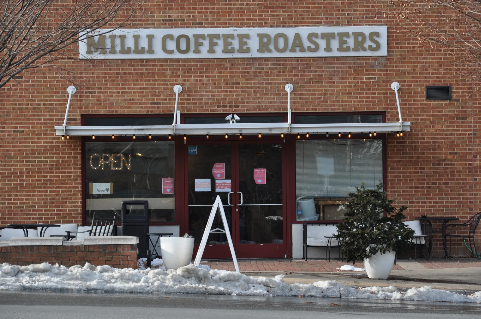 milli coffee roasters storefront with brick facade, open sign, and winter snow on ground., milli coffee roasters, virginia