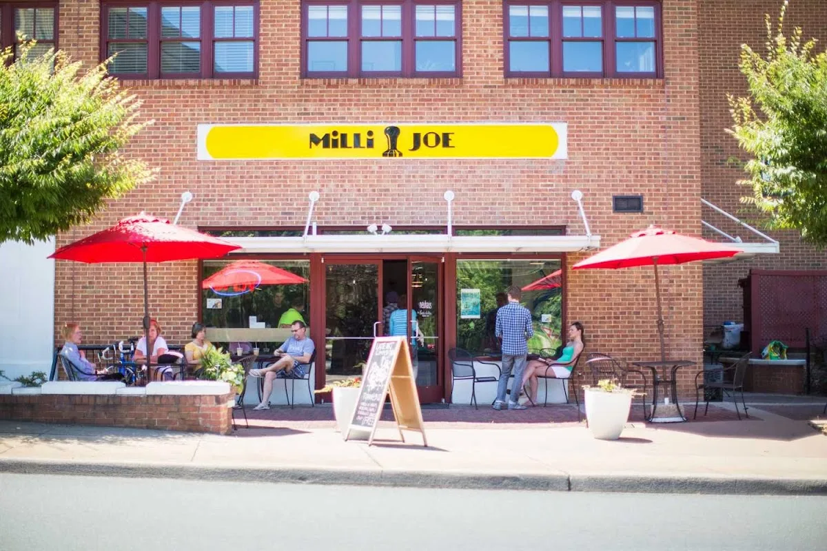 milli joe café with red umbrellas, brick building, outdoor seating, customers dining., milli coffee roasters, virginia