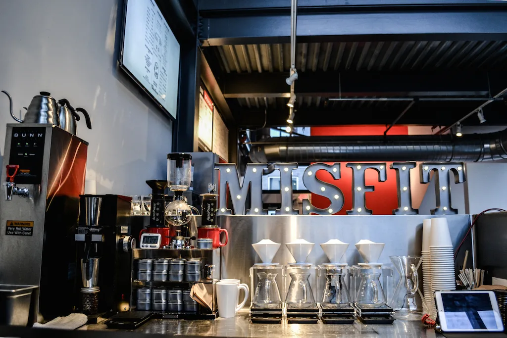 professional coffee bar counter with espresso machine, grinders, and misfit signage., misfit coffee, minneapolis