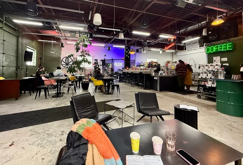 modern coffee shop interior with neon signs, lounge seating, and colorful lighting., misfit coffee, minneapolis