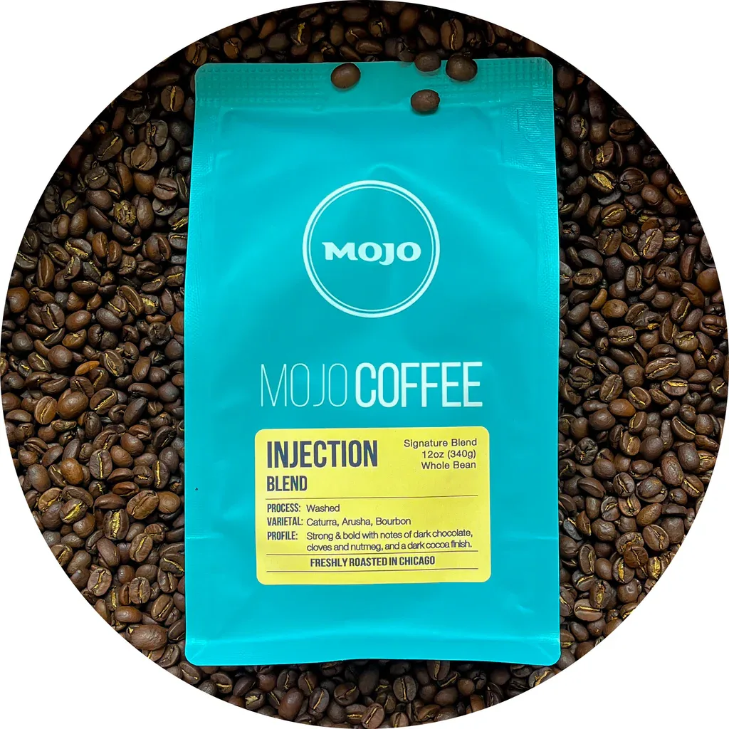 mojo coffee injection blend package surrounded by roasted coffee beans., mojo coffee, chicago