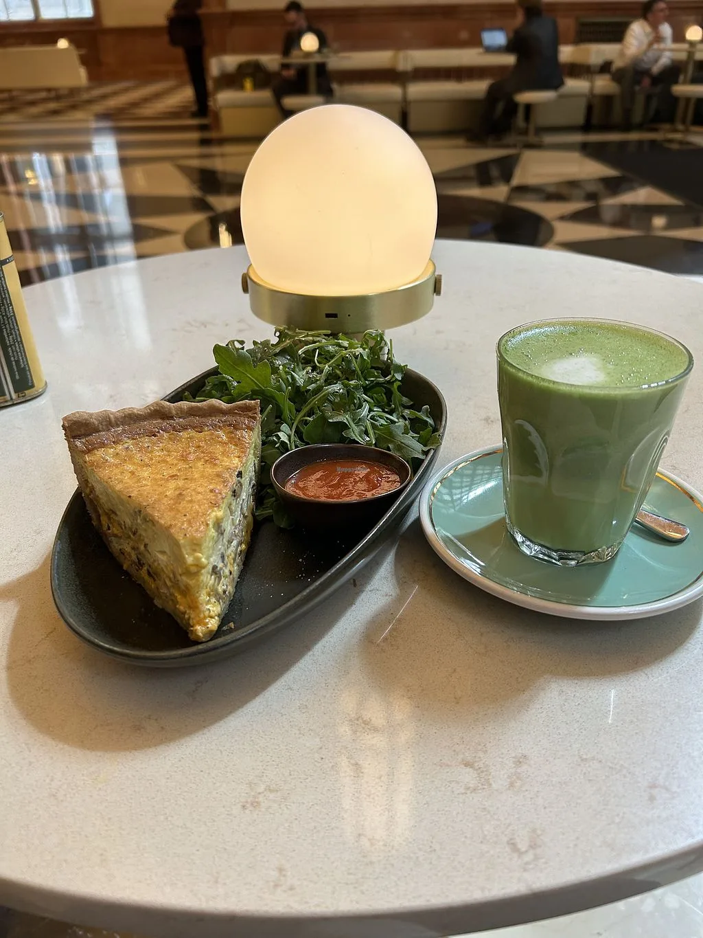 plated lunch with savory pie, greens, sauce, glowing lamp, and matcha beverage., mojo coffee, chicago