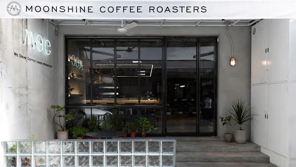 moonshine coffee roasters storefront with plants and modern minimalist entrance design., moonshine coffee roasters | 私釀咖啡商行 (