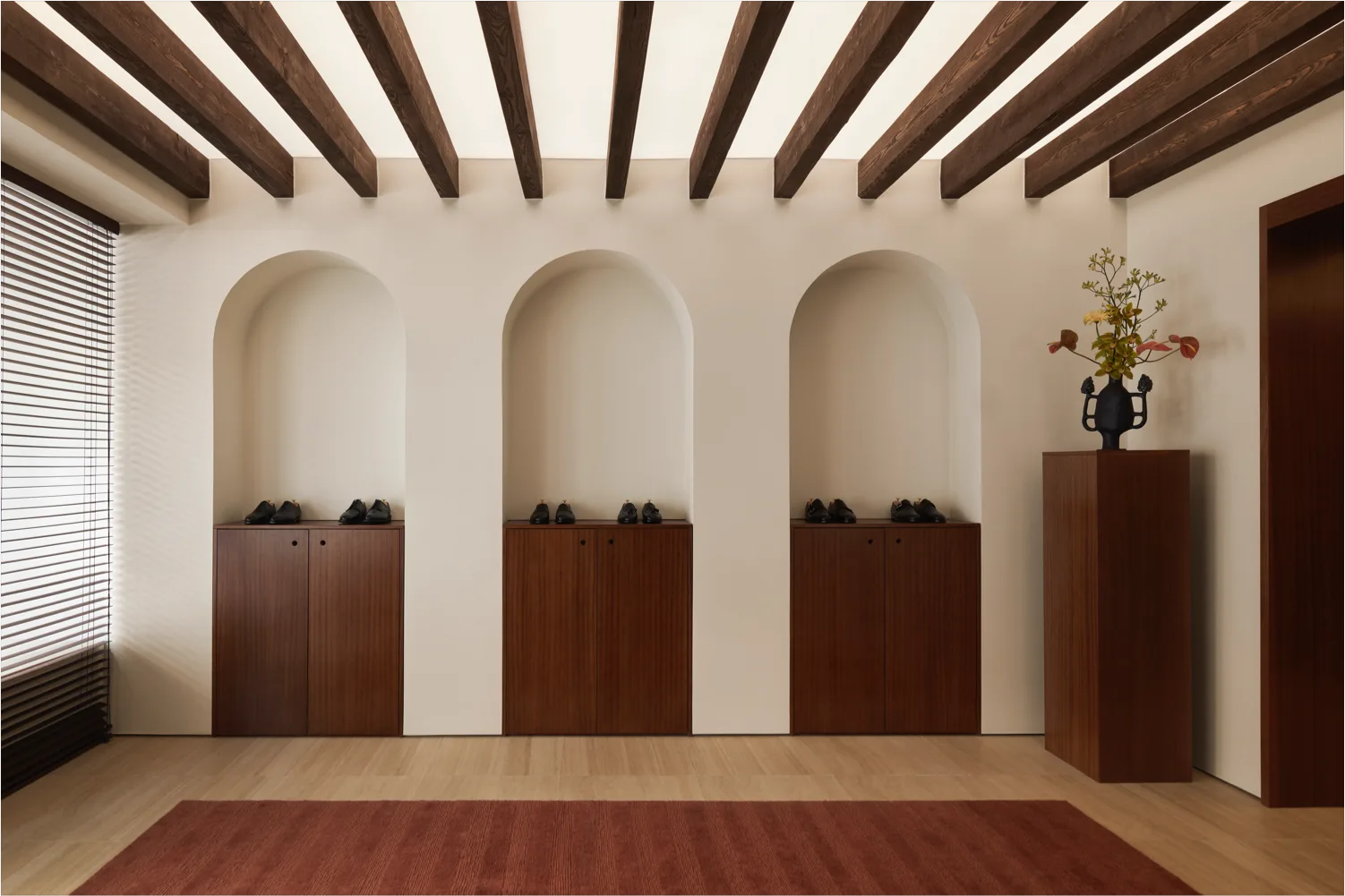 modern minimalist entryway with three arched alcoves, wooden cabinetry, and exposed beams., morjas flagship store, stockholm