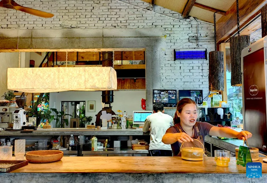 café counter with staff serving, industrial brick walls, wooden beams, and plants., mr piki (north district), wenyuan village