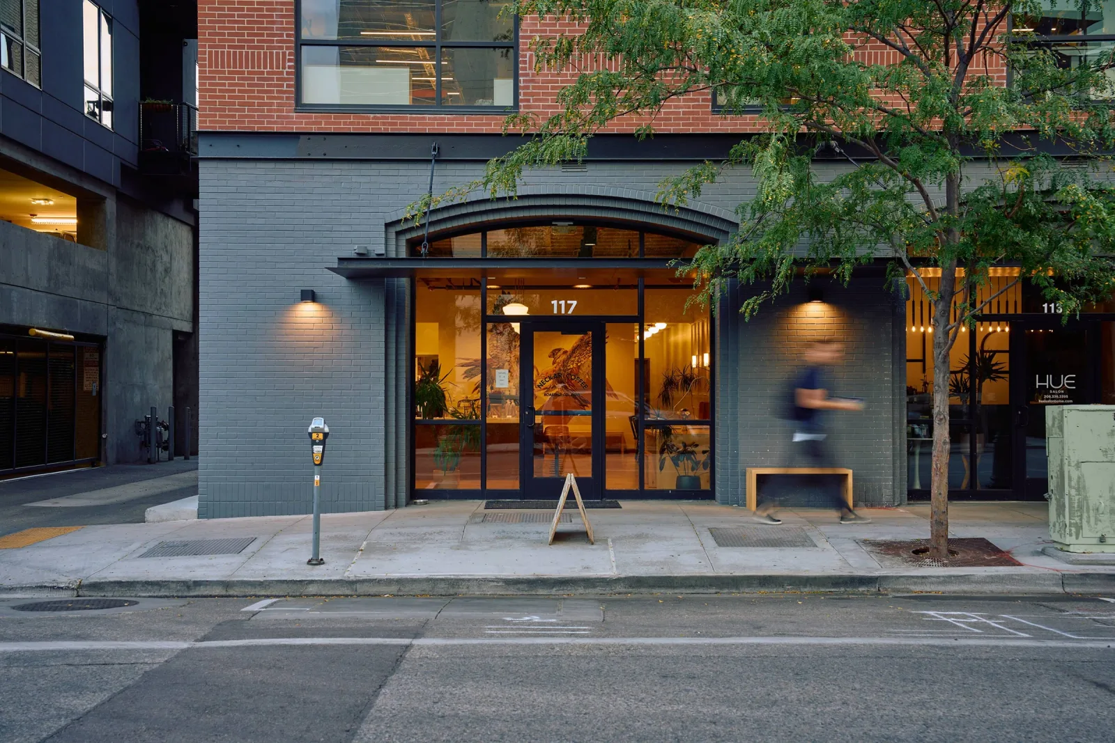 modern storefront at 117 with warm lighting and brick architecture above., neckar coffee, boise
