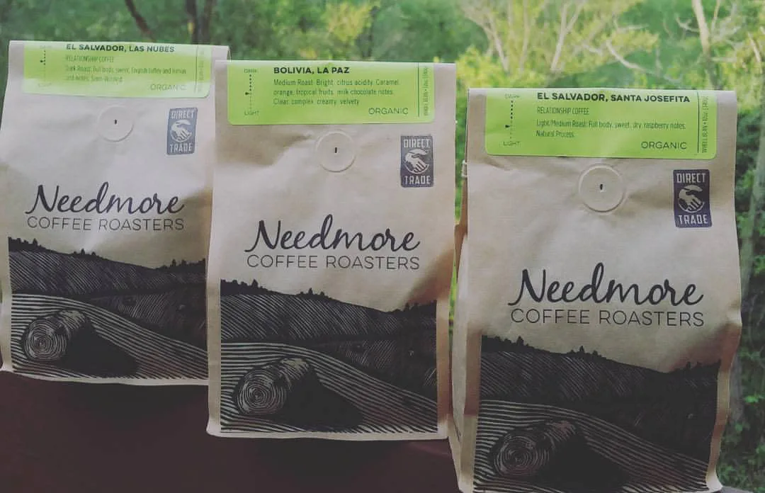 three bags of needmore coffee roasters single-origin organic coffee with green labels., needmore coffee roasters, bloomington