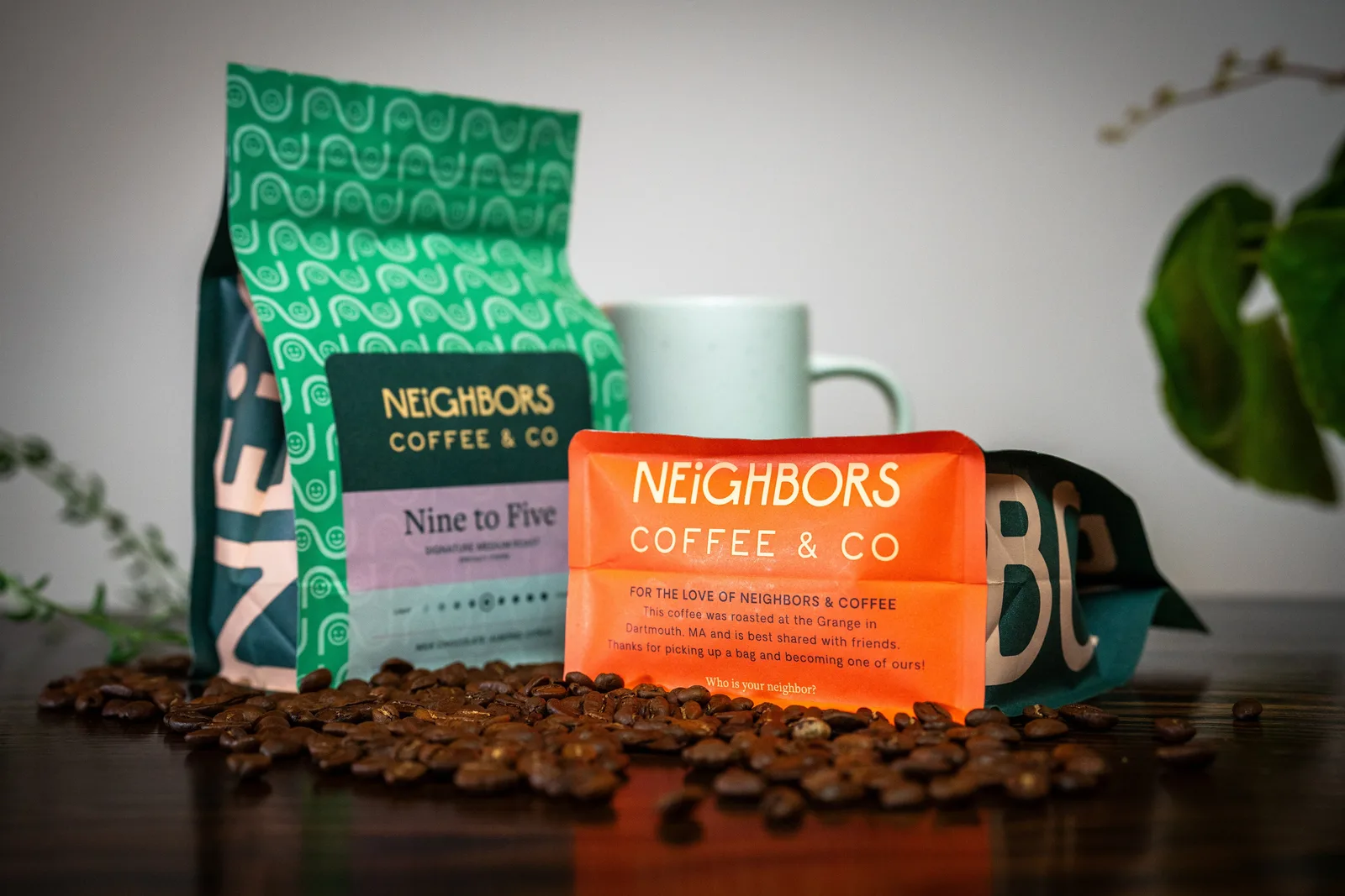 neighbors coffee & co products displayed with mug, coffee beans, and potted plants., neighbors coffee & co., taunton