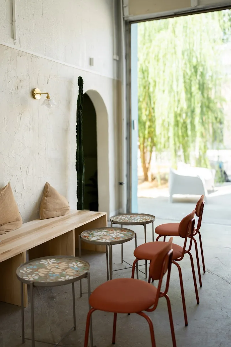 modern interior space with terracotta chairs, patterned tables, and natural light., neighbors coffee & hospitality, kansas ci