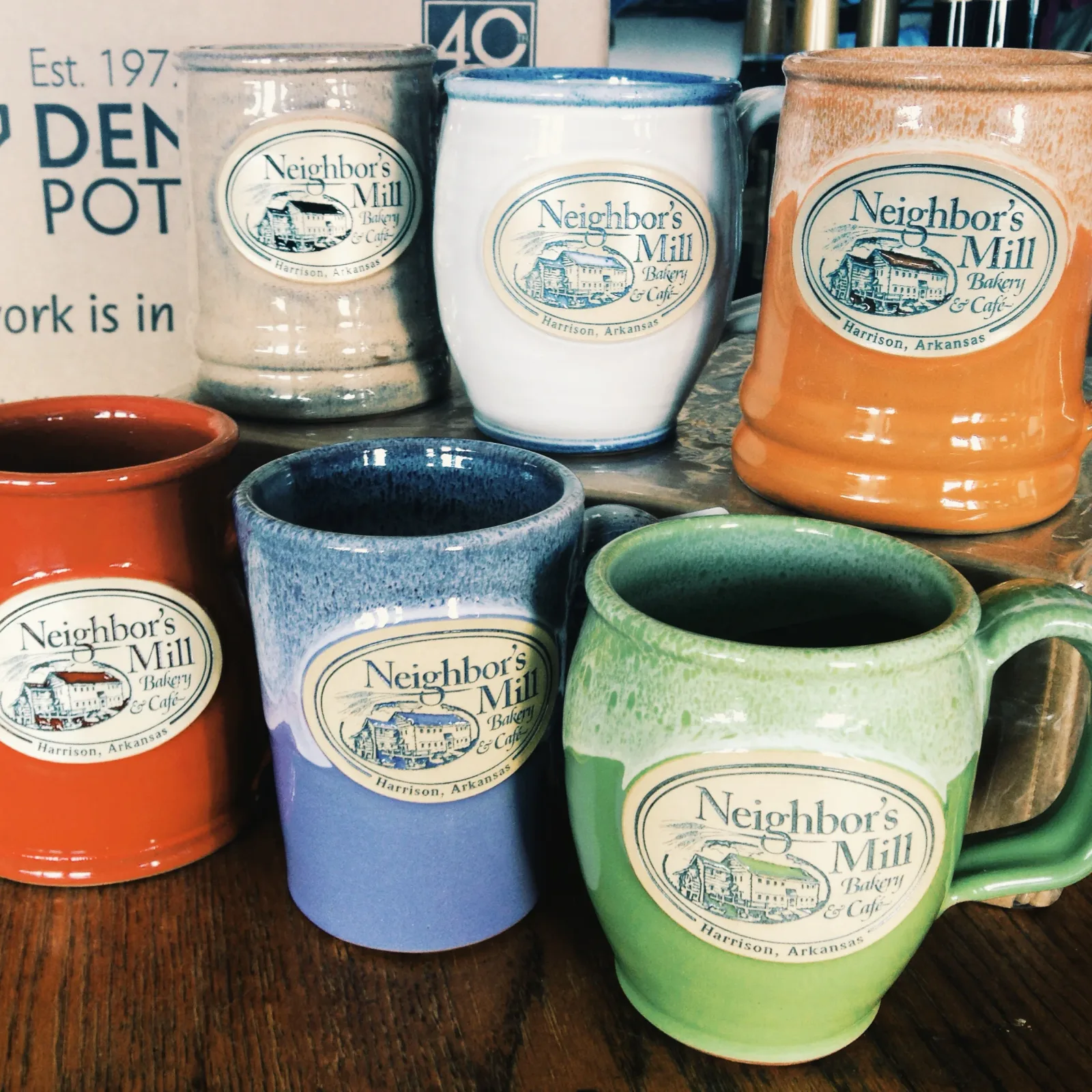 neighbor's mill bakery and cafe mugs and cups in various colors displayed together., neighbor's mill bakery & cafe, harrison