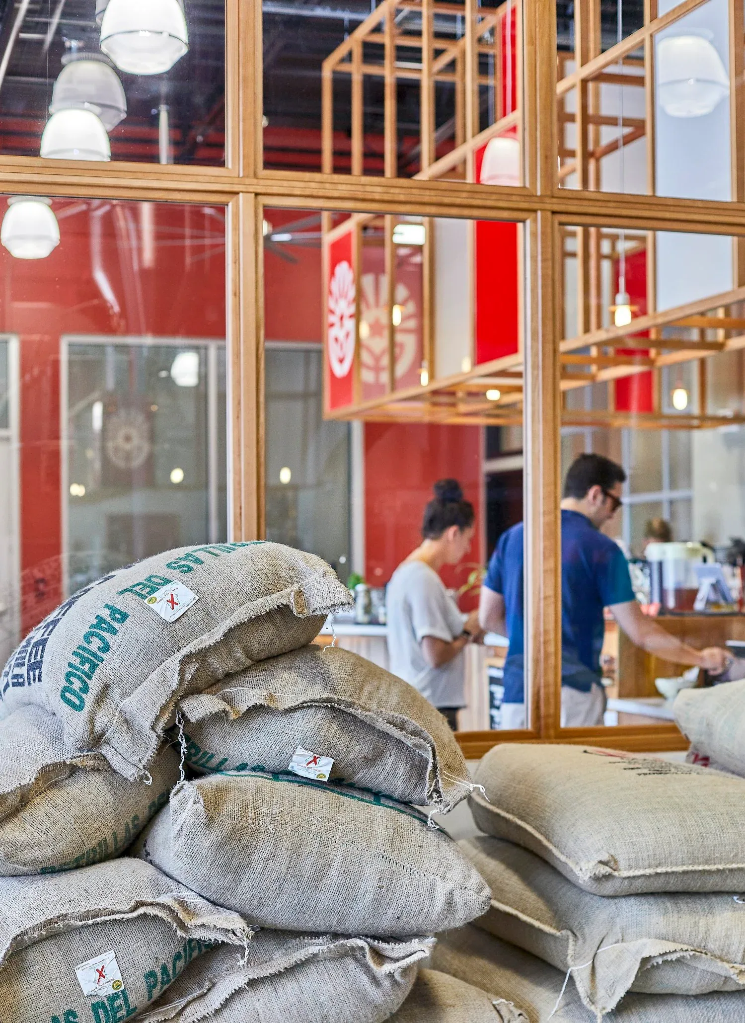 burlap coffee sacks displayed outside storefront with workers visible inside., new harvest coffee roasters, providence