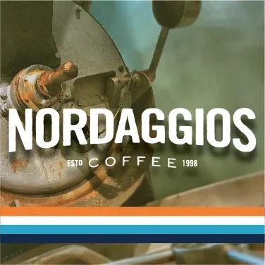 vintage coffee grinder mechanism with "nordaggios" text and established 1998 branding overlay., nordaggio's coffee, tulsa