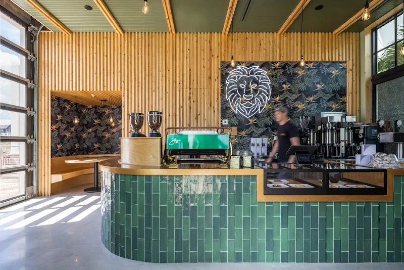 modern coffee shop interior with green tile counter and wooden slat walls., o&a coffee and supply, sarasota
