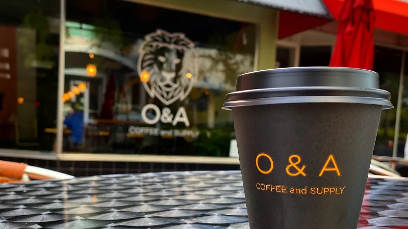 o&a coffee and supply cup on outdoor table with storefront visible behind., o&a coffee and supply, sarasota