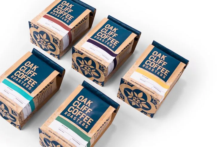 five packaged bags of oak cliff coffee roasters in various colored label varieties arranged diagonally., oak cliff coffee roa