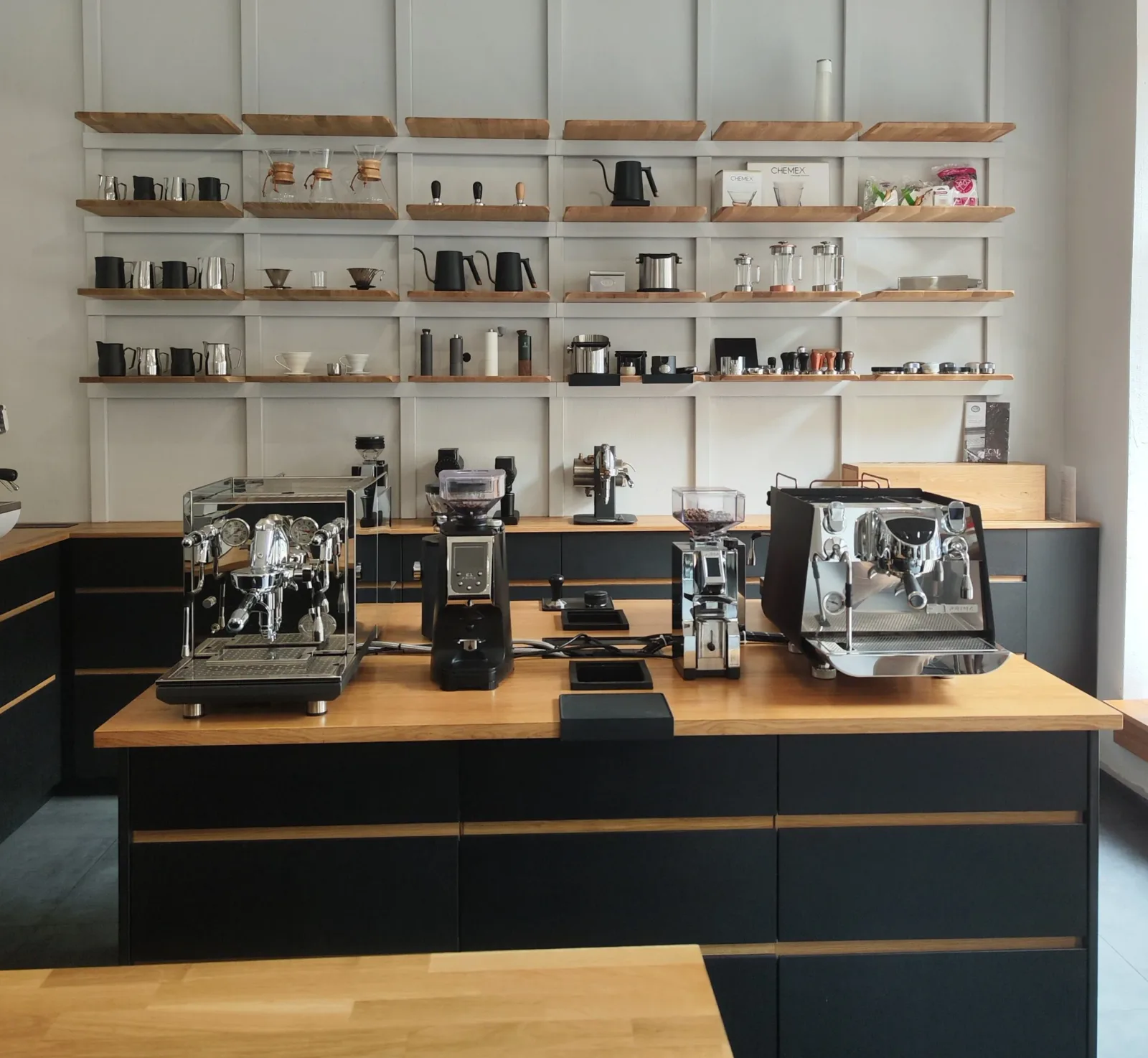 modern coffee shop counter with espresso machines and organized shelving display., obenauf kaffeemanufaktur gmbh (rösterei & 