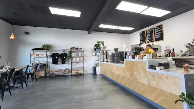 modern café interior with wooden counter, plants, and menu boards on walls., offset coffee co., el segundo