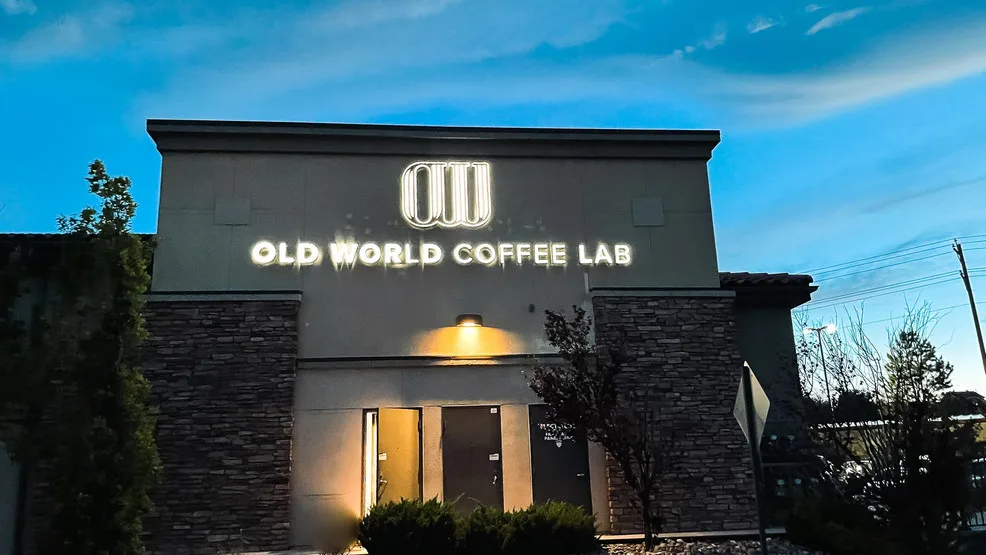 modern coffee shop storefront with illuminated neon signage at dusk., old world coffee lab, reno