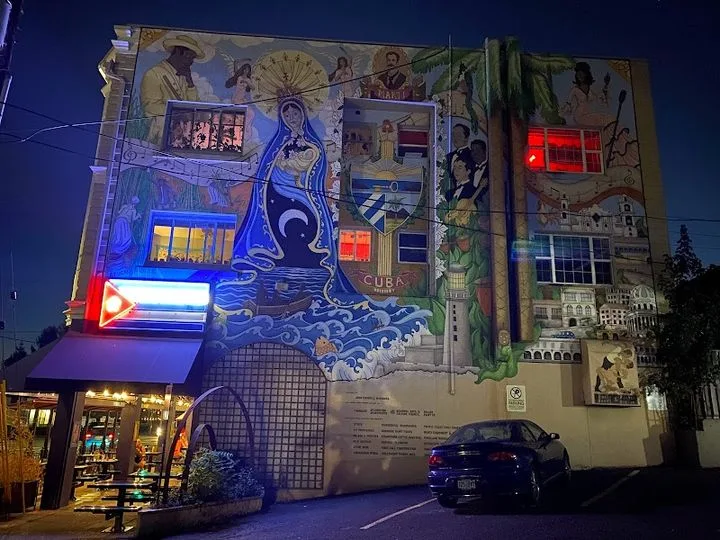 large illuminated mural on building facade with blue neon lighting at night., pambiche, portland
