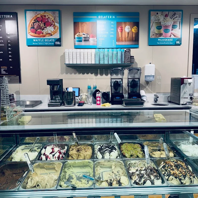 gelato shop counter with multiple flavors displayed in freezer case below., paradis gelateria tjuvholmen, oslo