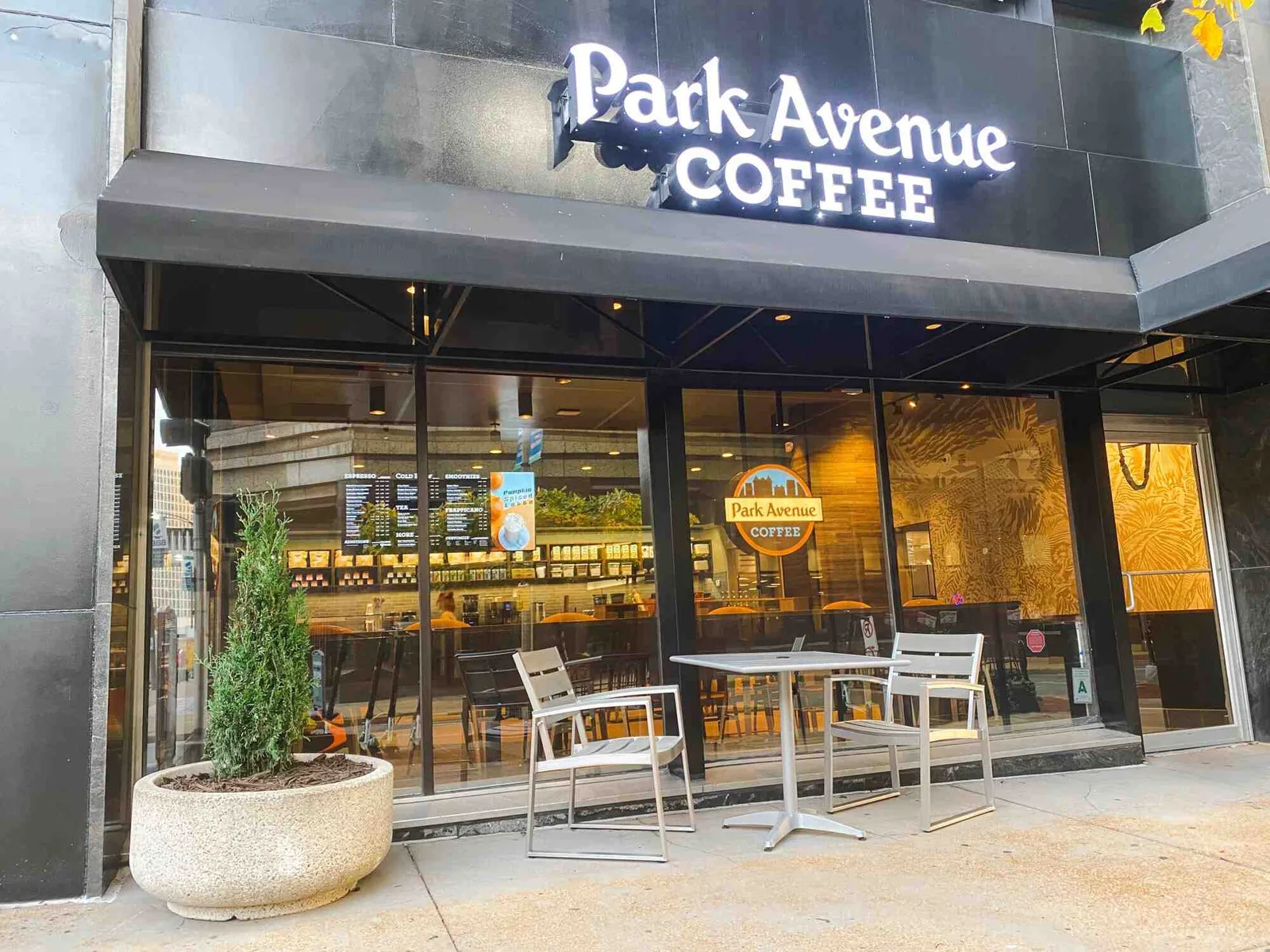 park avenue coffee storefront with illuminated signage, large windows, and outdoor seating., park avenue coffee roasters, st.
