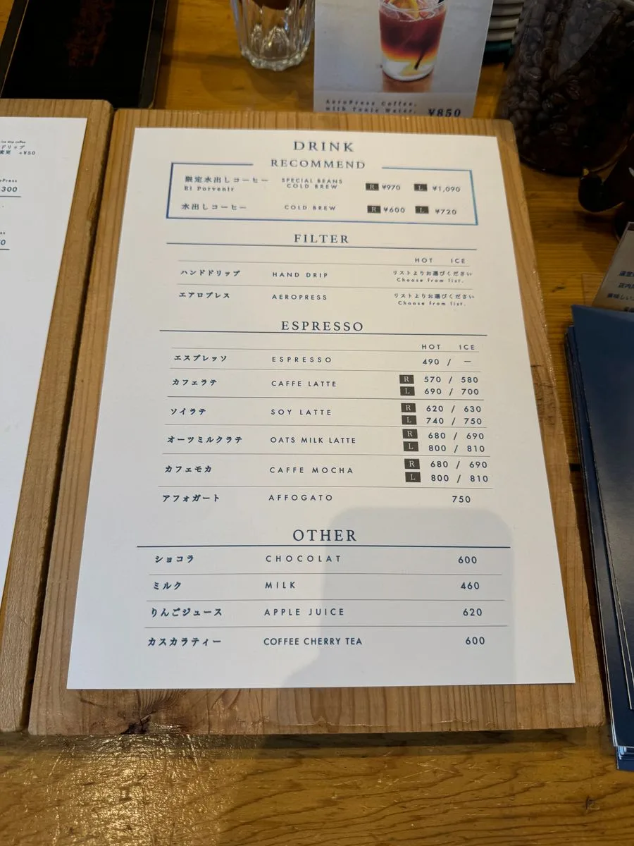 coffee shop menu displayed on wooden board with japanese and english text., passage coffee, tokyo