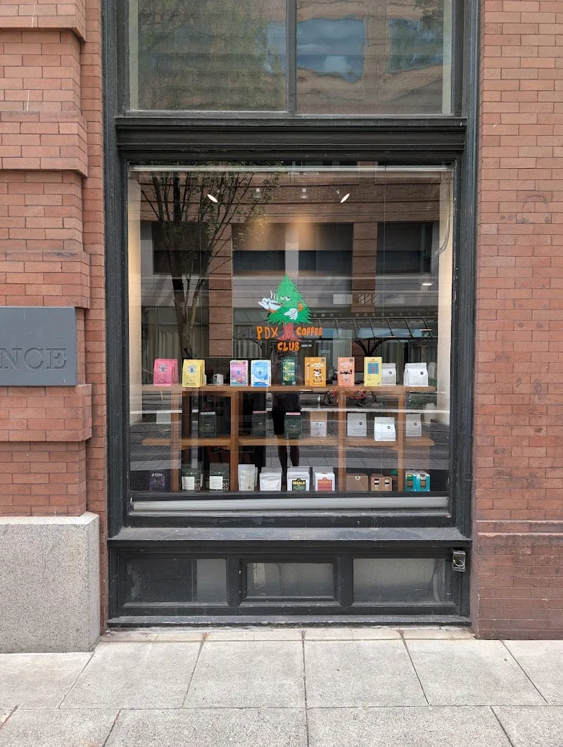 portland coffee shop storefront with colorful product boxes displayed in window., pdx coffee club, portland