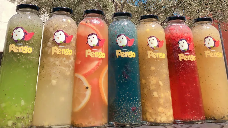 seven colorful penso brand beverages in glass bottles with tapioca pearls., pengo drink station, laguna hills