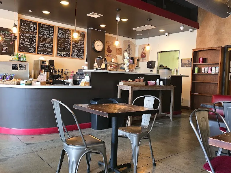 modern café interior with industrial chairs, wooden tables, and chalkboard menu boards., pilgrim's coffeehouse, fullerton