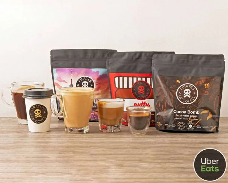 pirates coffee products displayed with various beverages and packaging on wooden surface., pirates of coffee, mississauga