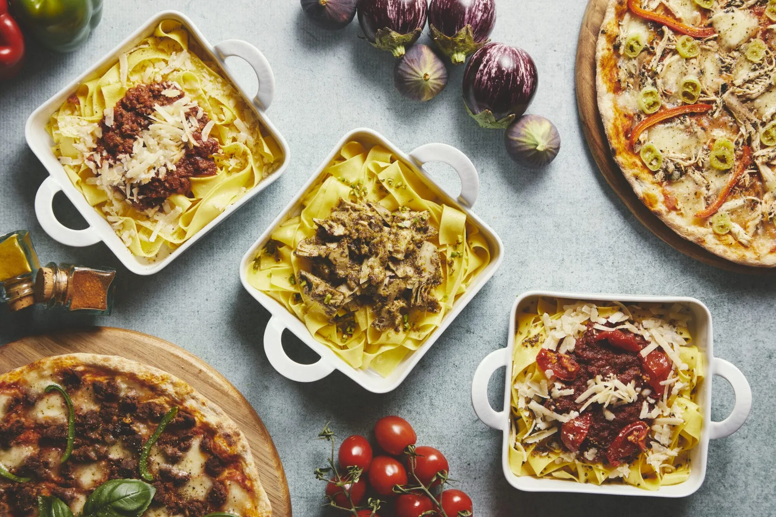 italian pasta dishes with pizzas, eggplants, tomatoes on gray surface., pomodoro d'oro, copenhagen