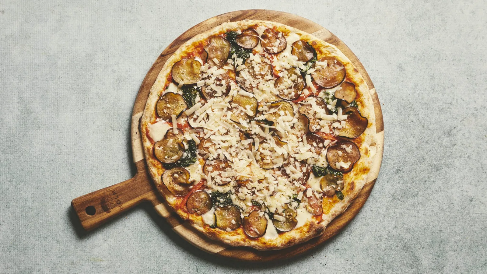 wood-fired pizza with sausage, mushrooms, cheese, and dark leafy greens on board., pomodoro d'oro, copenhagen