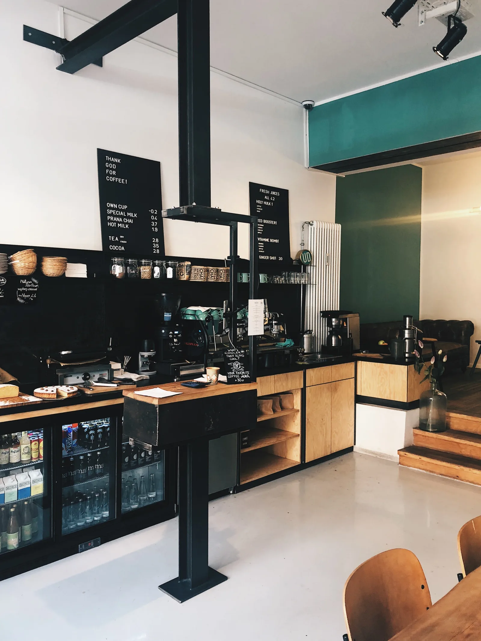 modern coffee shop interior with black counter, wood accents, and teal wall., prairiefire coffee roasters, wichita
