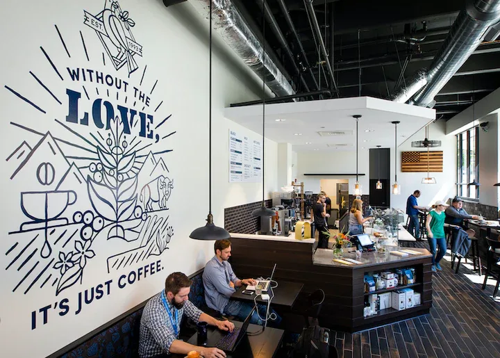 modern coffee shop interior with mural wall art and bustling counter service., pt's coffee, topeka