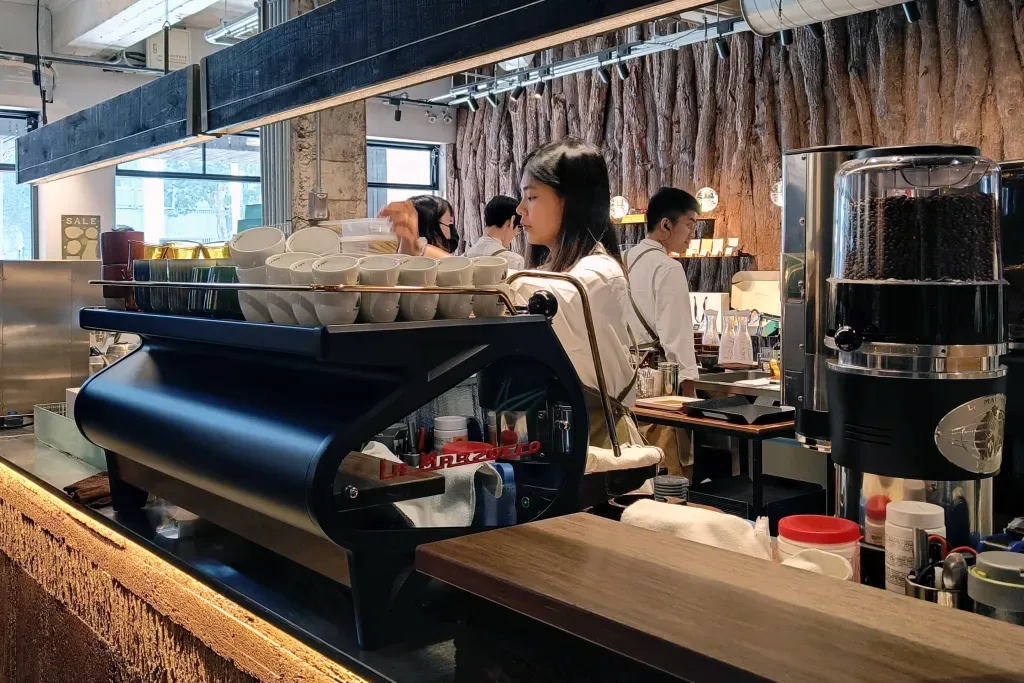 modern coffee shop interior with baristas working behind espresso machine counter., pure coffee, taipei