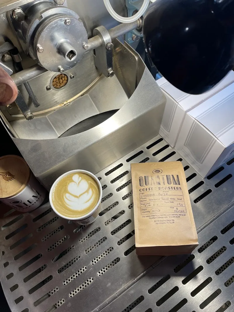 specialty espresso machine with latte art cup and quantum coffee roasters bag., quantum coffee roasters, san antonio